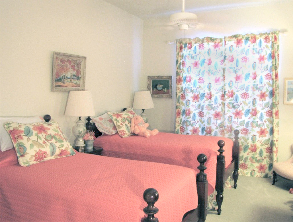 Bedroom with ceiling fan and closed curtains